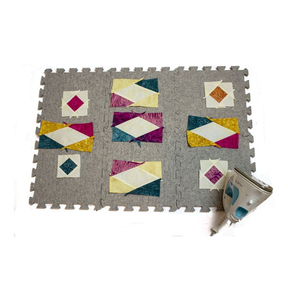 Quilting blocks and iron on Wool Press n Lock Tiles wool pressing mat on grey design wall