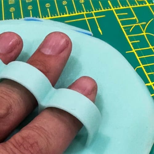 Mint green silicone finger exerciser for grip strength, perfect as a handy mat scrubber