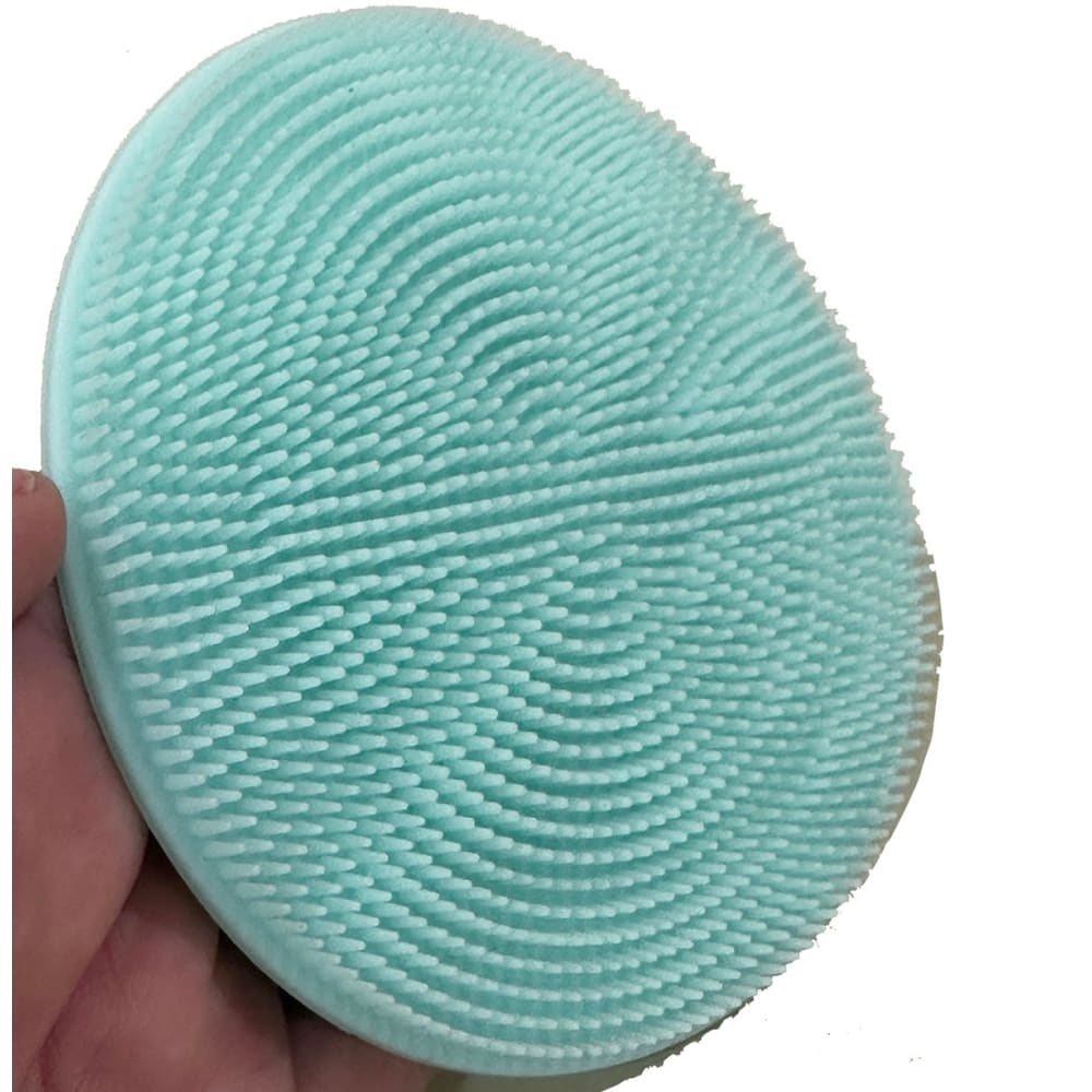 Mint green silicone facial cleansing brush with textured nubs, perfect as a handy mat scrubber or cutting mat scrubber