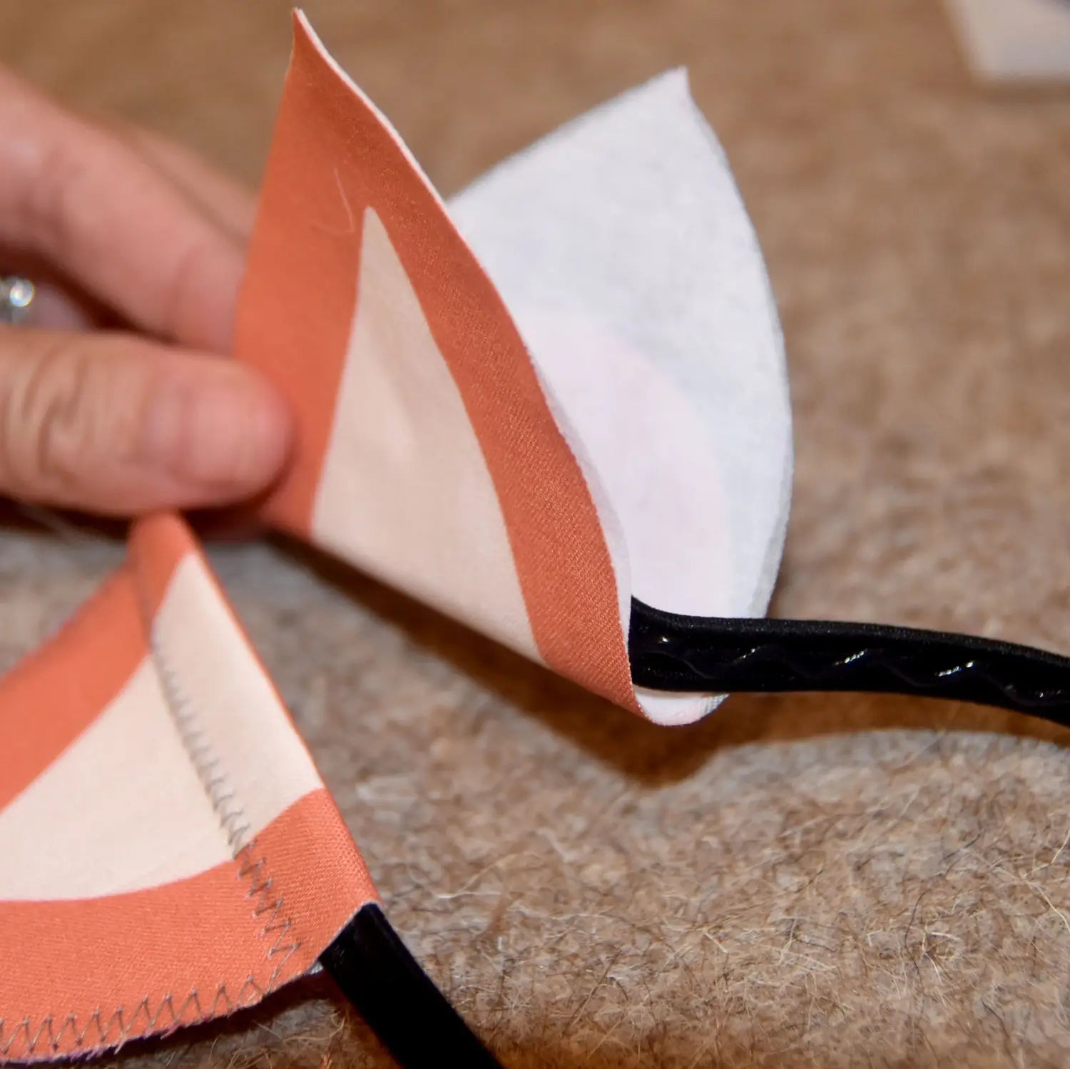 Fold ear over headband