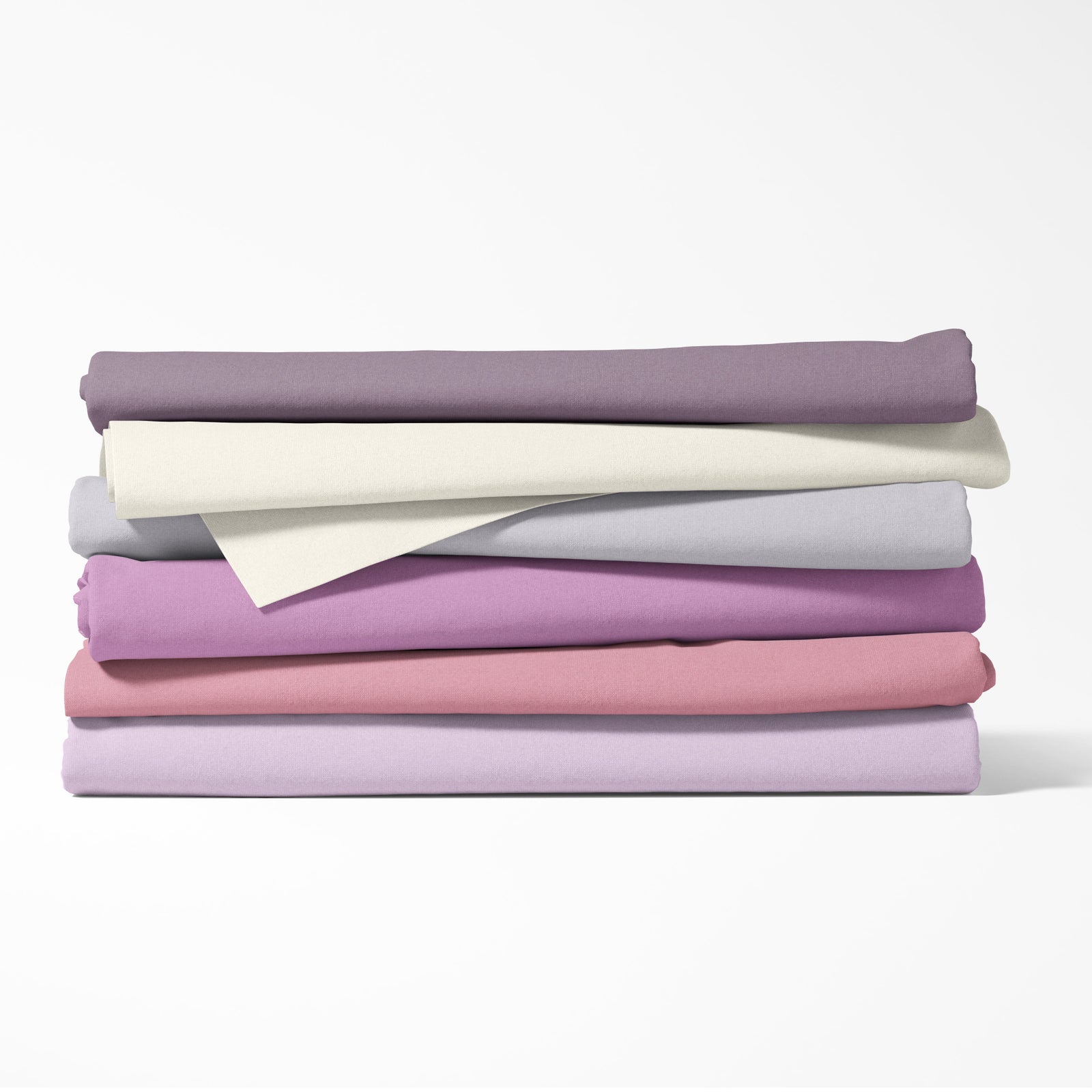 Stack of folded fabric sheets in various pastel colors on a white background