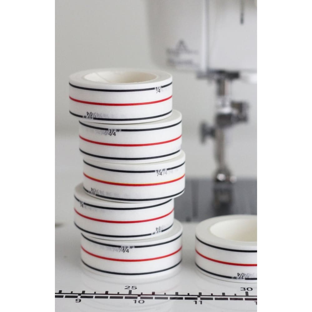 White diagonal seam tape with black and red lines for drawing diagonal lines in seams