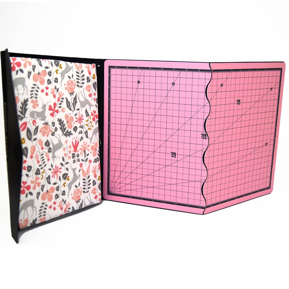 Black-bound Sewing Station with floral fabric pattern and pink cutting mat surface